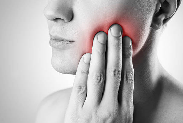 woman suffering from emergency tooth pain
